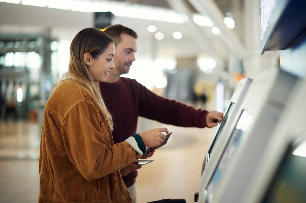 couple using a kiosk at a terminal