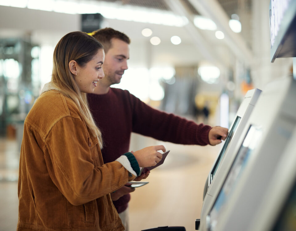couple using a kiosk at a terminal
