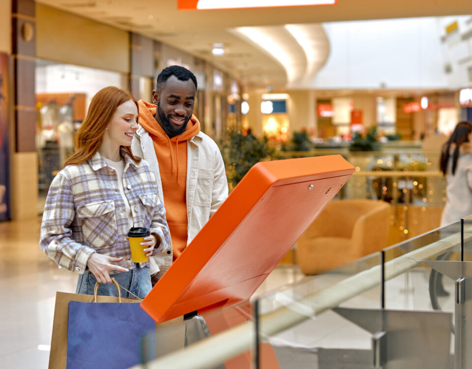 Shoppers viewing a mall kiosk
