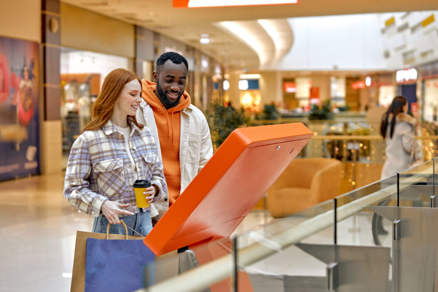 Shoppers viewing a mall kiosk