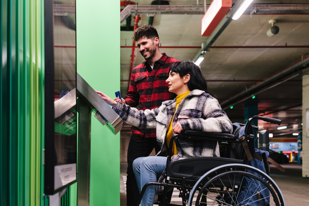 woman in a wheelchair using a touch screen kiosk